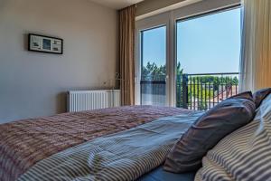 Posteľ alebo postele v izbe v ubytovaní Profi Kecó Apartman
