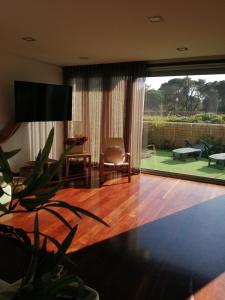 a living room with a large sliding glass door with a patio at Sunny Ofir in Fão