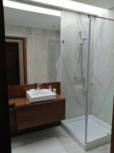 a bathroom with a sink and a shower at Sunny Ofir in Fão +24 photos