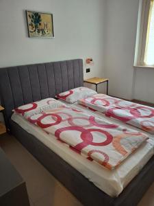 a bed with a red and white blanket on it at Schöne Ferienwohnung mit herrlichem Seeblick in Tignale +23 photos