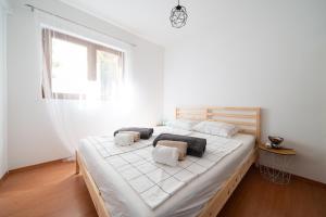 a bedroom with a large bed with white sheets and pillows at Holiday home SeVeN - Barefoot by the Sea, Velebit, Nature in Starigrad-Paklenica