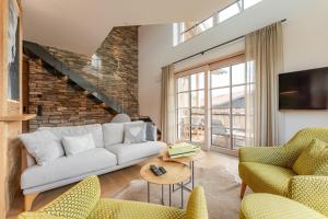 a living room with a couch and two chairs at Penthouse No9 in Oberstaufen