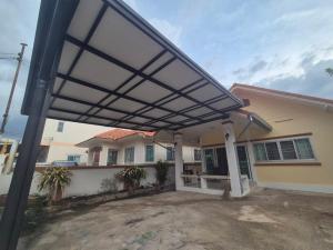 a pergola over the front porch of a house at 94 Yellow house in Khon Kaen