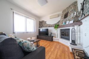 a living room with a couch and a fireplace at Holiday home SeVeN - Barefoot by the Sea, Velebit, Nature in Starigrad-Paklenica