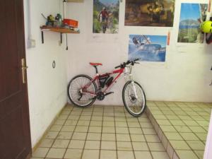 a bike is parked in a corner of a room at Ferienwohnung CASTELLO mit schöner Dachterrasse in Nago-Torbole