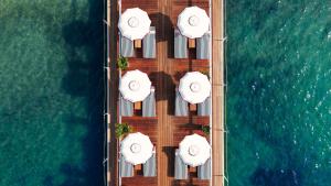 an overhead view of a deck with white umbrellas at Hôtel Barrière Le Majestic Cannes in Cannes