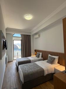 a hotel room with two beds and a window at Hotel Old Town in Batumi +55 photos