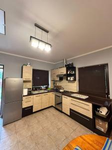 a kitchen with a refrigerator and a counter top at Noclegi na Szczęśliwej 1 w Okunince in Okuninka