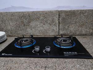 a black table with two stove tops on a table at Marutham Farm House in Jaffna