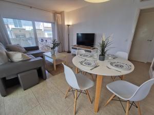 a living room with a white table and chairs at Apartamento en Platja d'Aro: A/C, Parking, a 2 Pasos de la Playa, 3 Hab, Terraza. - ES-209-12 in Platja  d'Aro