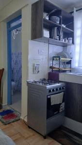 a kitchen with a stove top oven in a kitchen at Haven Studio in Ongata Rongai 