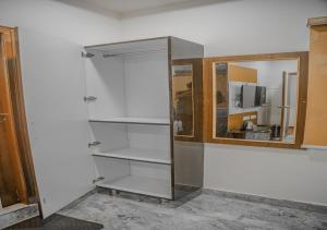 a bathroom with a glass door and a mirror at Hotel Vayuputra Grand in Secunderabad