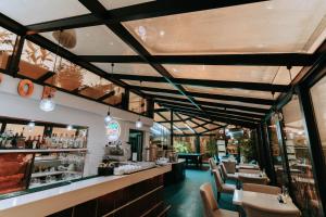 a restaurant with tables and chairs and a bar at Hotel Old Town in Batumi
