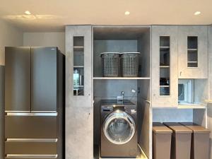 a kitchen with a refrigerator and a washing machine at グラン熱川 in Higashiizu +11 photos