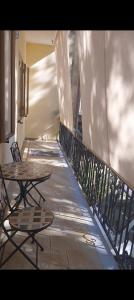 a balcony with tables and chairs on a building at House on the road in Telti
