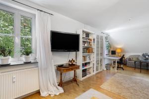 a living room with a flat screen tv on a wall at Schöne Dachgeschoss Wohnung in Warstein