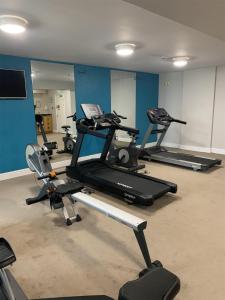 a gym with several tread machines in a room at Park Inn by Radisson Shannon Airport in Shannon