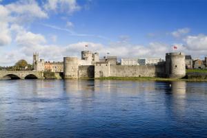 a castle with a bridge over a body of water at Park Inn by Radisson Shannon Airport in Shannon