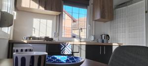 a kitchen with a counter and a large window at Lemon & Lime Apartmanok Mikepércs Debrecen közelében in Mikepércs +17 photos