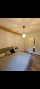 a bedroom with a large bed and a ceiling at Rural apartment La Cantonada in Guardiola de Berguedà