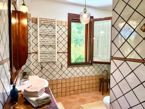 a bathroom with a sink and a toilet and a window at La Segreta in Marina di Casalvelino +90 photos