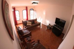 a living room with a couch and a television at MR11 Guest House in Campinas