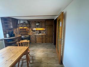 a kitchen with wooden cabinets and a wooden table at Landhaus - In der hohen Eich Eg in Überlingen +22 photos