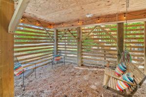 a porch with two chairs and a swing at 5517 - Harbour Haven in Kill Devil Hills