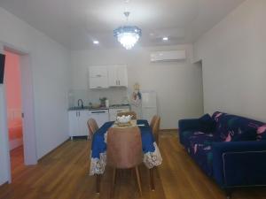 a living room with a table and a kitchen at sopo's cottage in Kobuleti