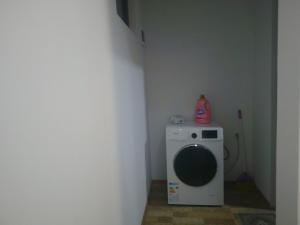 a washing machine in a corner of a room at sopo's cottage in Kobuleti