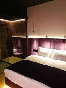 a bedroom with a large bed and a glass shower at Stolarnia Winehouse in Łaziska Górne