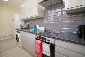 a kitchen with a stove and a counter top at Warwick Row Apartments Coventry City Centre - Flat 3 in Coventry