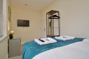 a bedroom with a bed with towels on it at Warwick Row Apartments Coventry City Centre - Flat 3 in Coventry