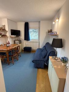 a living room with a table and a dining room at Casa Dolce Presena in Passo del Tonale +47 photos