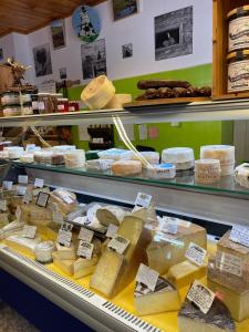 a display case in a grocery store with cheese at Le Genin - studio spacieux dans le centre de Gryon in Gryon