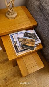 a wooden table with magazines on a coffee table at Quakers Field View in Pennington