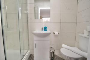a white bathroom with a sink and a toilet at Warwick Row Apartments Coventry City Centre - Flat 4 in Coventry +9 photos