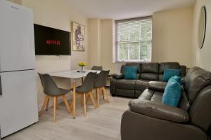 a living room with a couch and a table at Warwick Row Apartments Coventry City Centre - Flat 4 in Coventry