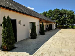 a white building with trees in the courtyard at Garden Hotel in Akhalk'alak'i