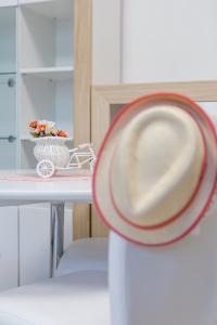 a hat on top of a table with a bowl of food at Tevi Apartments in Varna City