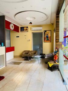 a living room with a couch and a table at Arton By Hotel Avion Palace - Near International Airport in Mumbai +8 photos