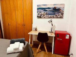 a small room with a desk and a red refrigerator at 0001 - Pousada HG quarto home office, duplo in Vila Gopoúva