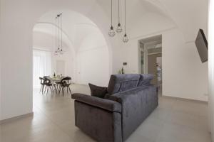 a living room with a couch and a table at Amate' by BarbarHouse in Ruffano