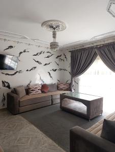 a living room with fish painted on the wall at فيلا بمولاي بوسلهام in Kenitra