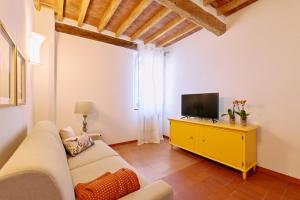 a living room with a white couch and a television at Casa Lippa in Spilamberto