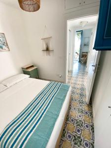 a bedroom with a bed and a hallway with a floor at La Perla del Porto di Maratea House in Maratea