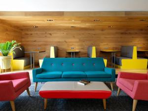 a living room with a blue couch and two chairs at For Students Only - Modern Rooms in York in York