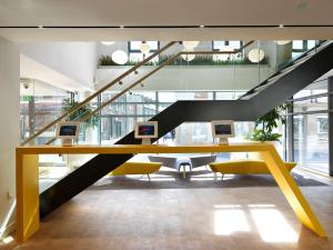 an office with a yellow desk and a staircase at For Students Only - Modern Rooms in York in York +25 photos