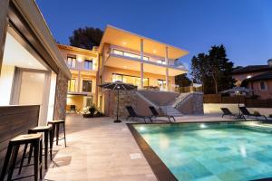 a house with a swimming pool in front of a house at Appart HOTEL 3 Chambres - parking - clim in Saint-Raphaël