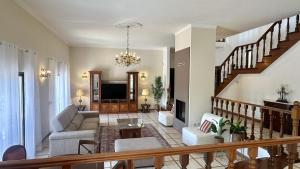 a living room with a couch and a staircase at Atanasio by Check-in Portugal in Albufeira